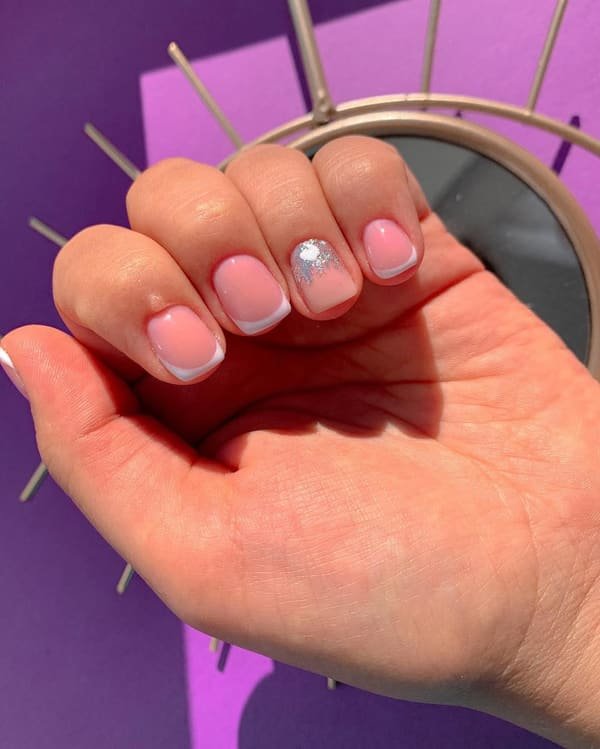 Short rounded pink Russian manicure with silver accent details