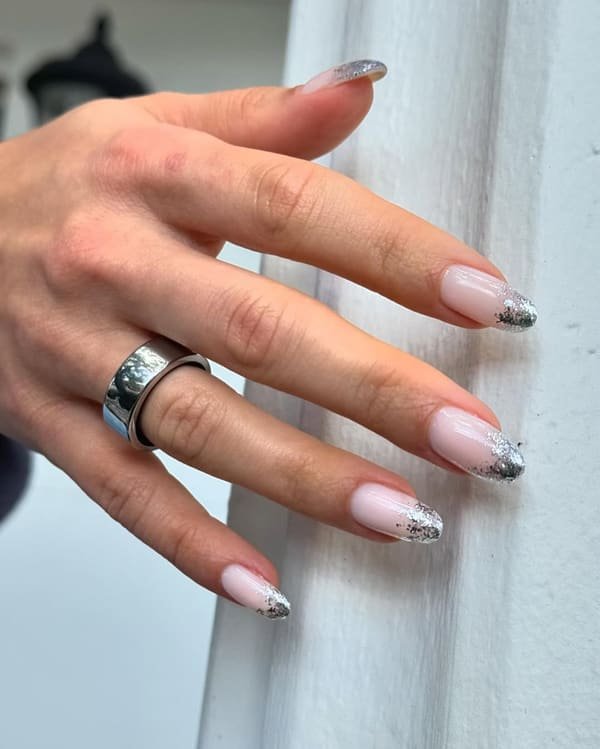 Pale pink almond nails with silver glitter French tips