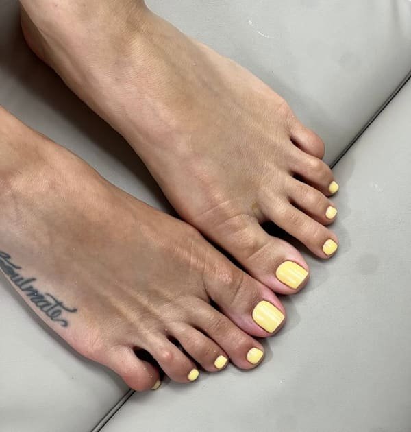 Bright yellow square gel pedicure on both feet