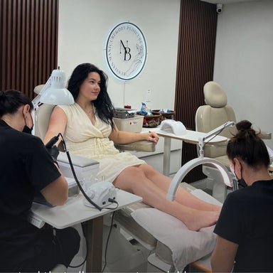 Client receiving a manicure and pedicure simultaneously at Nail Boss Studio